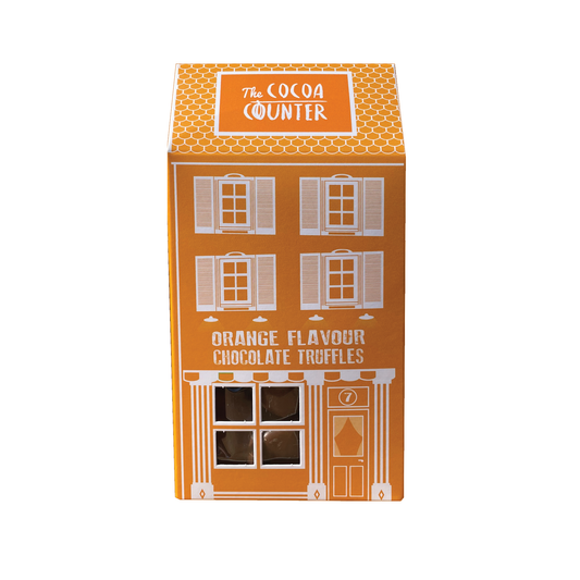 Orange Flavour Truffles placed in an orange box in the shape of a house.